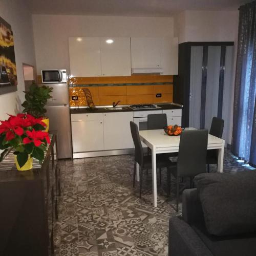 a kitchen and dining room with a table and a refrigerator at The Best House in Reggio Emilia