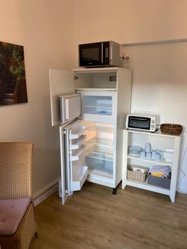 a refrigerator with its door open in a room at Schöne 2,5 Zimmer Wohnung in Dortmund-Hörde Phönix! in Dortmund