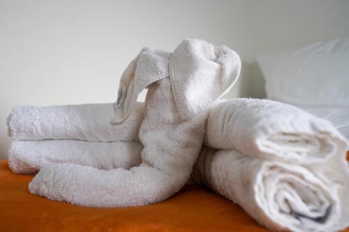 a pile of white towels sitting on a table at One-Bedroom Apartment: Sleeps 4 Comfortably in Berwick-Upon-Tweed