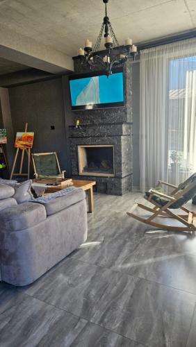 a living room with a couch and a fireplace at Best view Kazbegi in Kazbegi