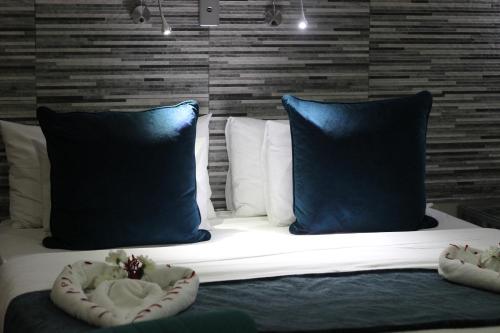 a large bed with two pillows and two at Ecolux Boutique Hotel in Komatipoort