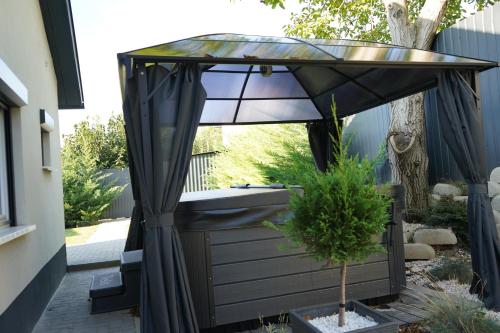 a bathroom with a sink under an umbrella at Secret Garden Vendégház in Pécs