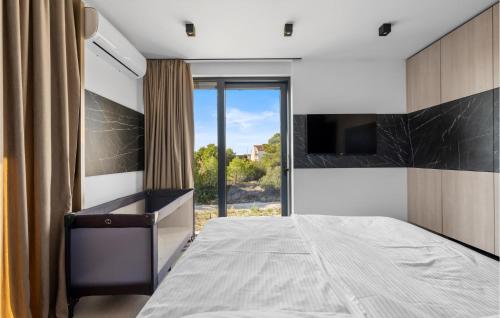 a bedroom with a bed and a large window at Gorgeous Home In Vodice With Sauna in Vodice