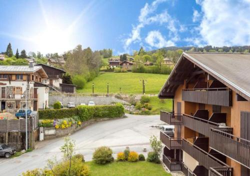 arial view of a house with a driveway and a yard at Les Aiguilles De Warens in Combloux