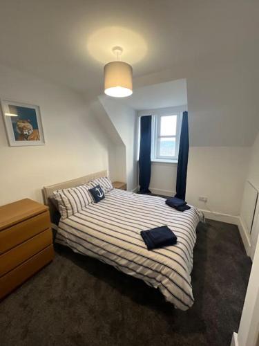 a bedroom with a bed with two pillows on it at Substantial 5 Bed Townhouse in Peterhead