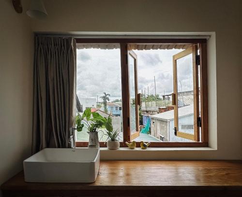 a bathroom with a large window with a bath tub at Forest Tag - 6/8 Ha Noi in Hue