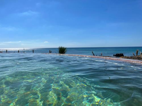 a swimming pool with the ocean in the background at Royal Azur Thalassa in Hammamet