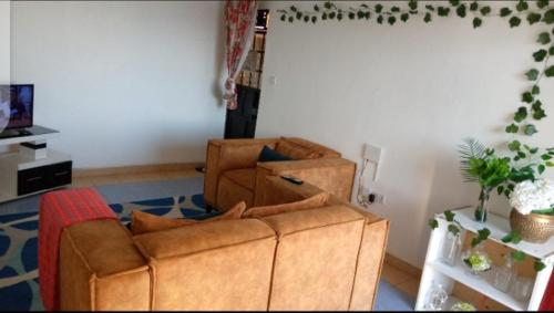 a living room with two chairs and a couch at Lovely one bedroom airbb in THIKA with WiFi ,ample parking-next to the road in Thika
