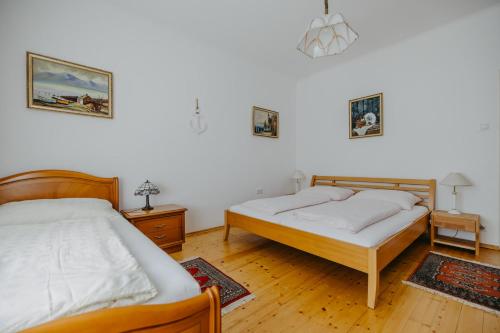 two beds in a room with two tables at Ferienhaus Wallern im Burgenland in Wallern im Burgenland
