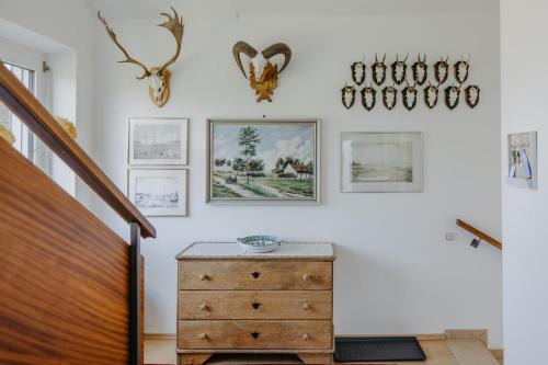a room with a wooden dresser and pictures on the wall at Ferienhaus Wallern im Burgenland in Wallern im Burgenland