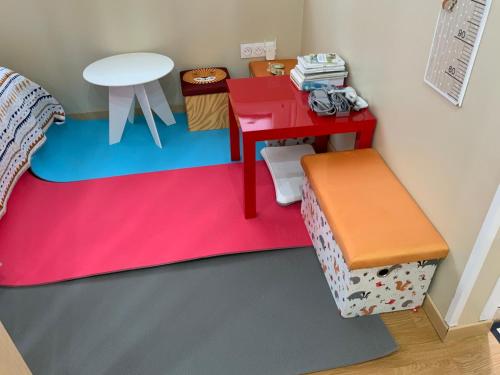 a toy room with a desk and a table at Family lodg in Calais