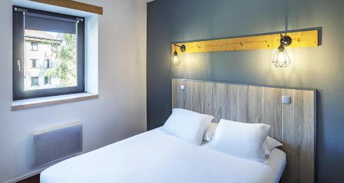 a bedroom with two white beds and a window at Sure Hotel by Best Western Annecy in Annecy