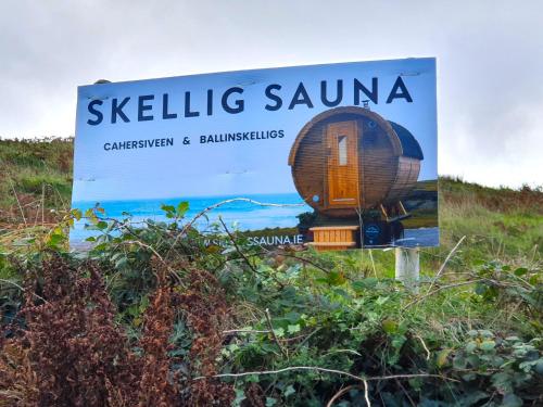 a sign for a tiny house on the beach at Shore Cottage on Valentia Island - Cosy comfort at the sea in Kerry in Valentia Island