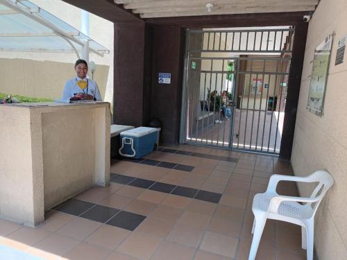 a man standing at a counter in front of a building at Beautiful Beach Apartment in Zazue in Santa Marta