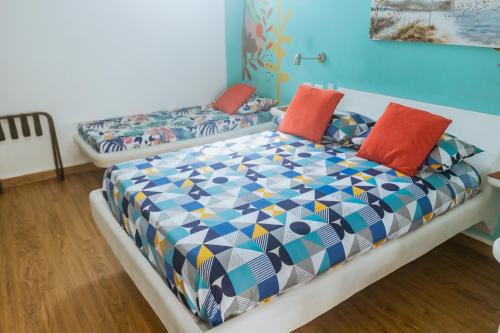 a bedroom with a bed with colorful pillows at King's Apartments 202 in Cartagena de Indias