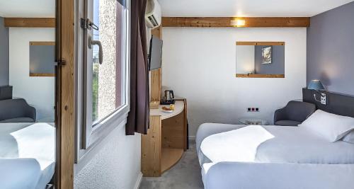 a small room with two beds and a window at Sure Hotel by Best Western Annecy in Annecy