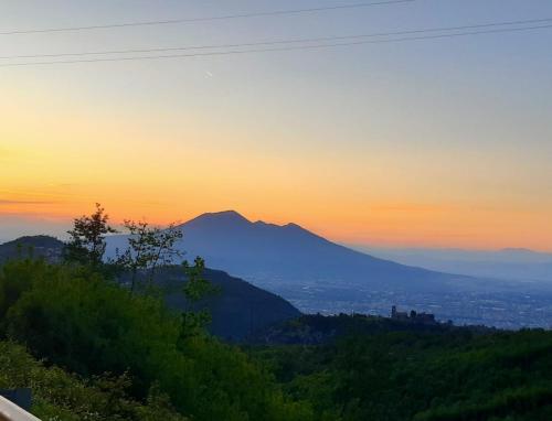 a view of a mountain with the sunset in the background at Agriturismo il Pettirosso in Agerola