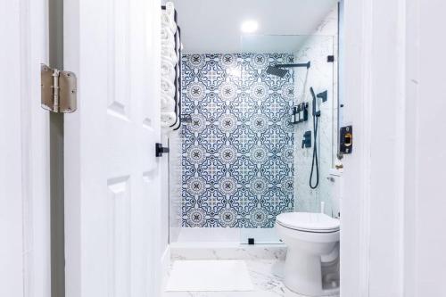 a white bathroom with a toilet and a shower at Serenity Lodge II Condo in Miami