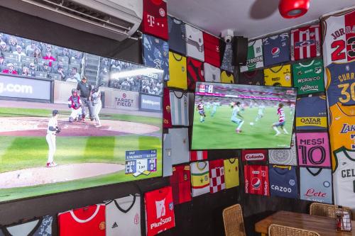 a room with two televisions and a baseball game at King's Apartments 202 in Cartagena de Indias