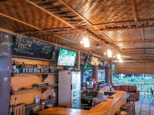a bar in a restaurant with a counter at Raffiel Nias in Lagudri