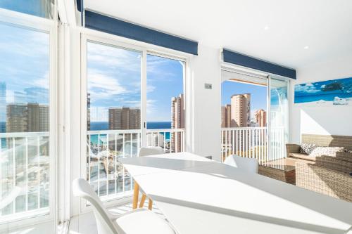 een witte eetkamer met uitzicht op de stad bij Don Paco 12-B Deluxe Apartment Levante Beach in Benidorm