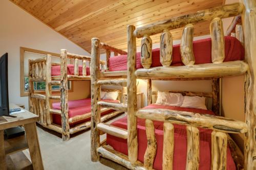 a log cabin bedroom with two bunk beds at 734 Disciples Village Condo in Boyne Falls