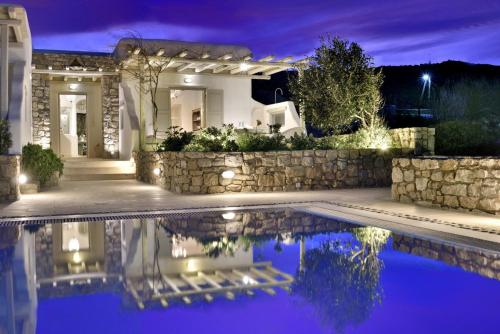 a house with a swimming pool at night at Villa Mon Rêve with Private Jacuzzi "5-minute walk - Ornos beach" in Mýkonos City