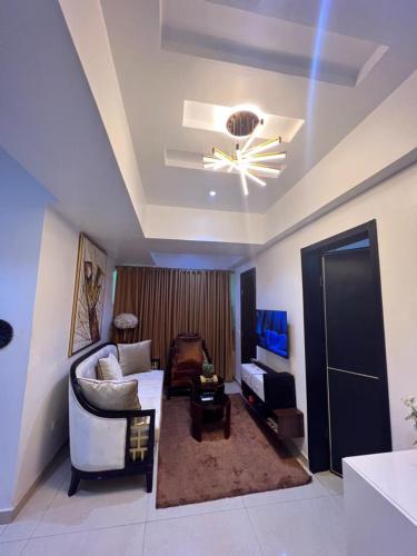 a living room with a couch and a ceiling fan at Patrick Court in Lagos