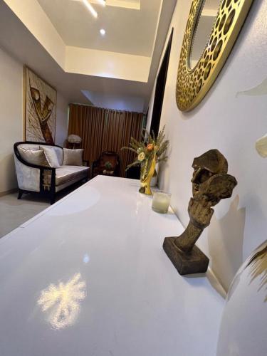 a room with a white table with a sculpture on it at Patrick Court in Lagos