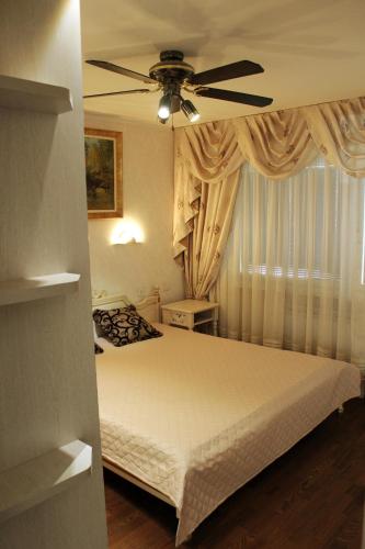 a bedroom with a bed and a ceiling fan at Avelana Apartment in Pärnu