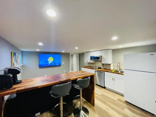 a kitchen with a counter and a tv on the wall at Green Lake 1st Line Home C Full Modern Remodeled in Seattle