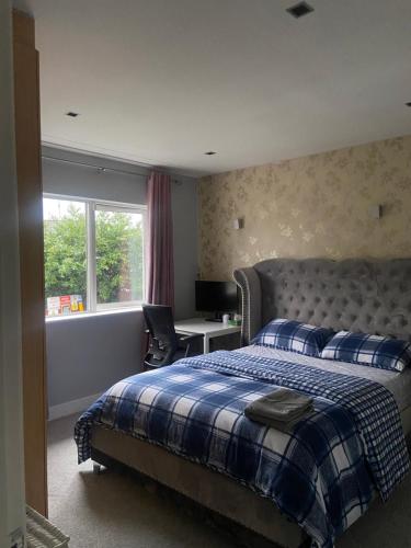 a bedroom with a bed and a desk and a window at Private shared room near Blanchardstown shopping center 