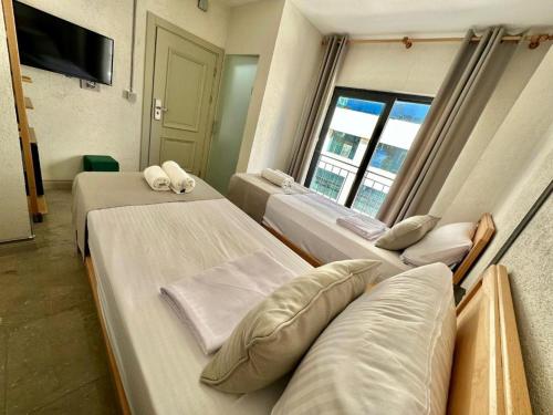 a hospital room with three beds and a window at Elegance House Hotel in Istanbul