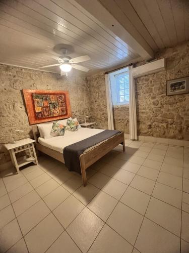 a bedroom with a bed in a room with a window at Inchcape Seaside Villas in Christ Church