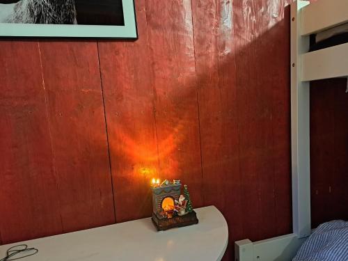 a candle sitting on top of a table in a room at Guesthouse Nature Trails Sweden in Övre Älgestad