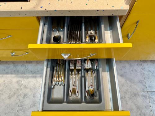 a drawer with utensils in a kitchen at PLAYA DEL CURA - Spacious Beachside Apartment in Playa del Cura