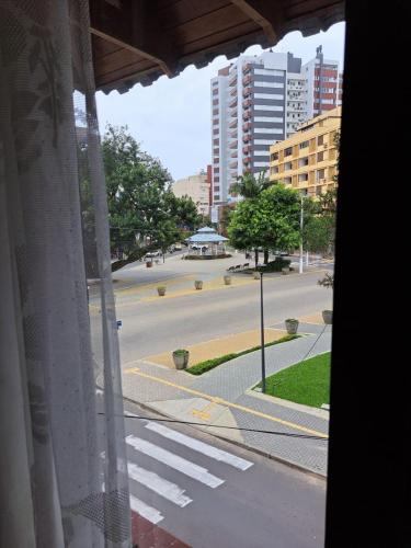 a view of an empty street from a window at Vitória Torres Hotel in Torres