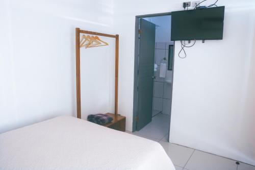 sypialnia z białym łóżkiem i lustrem w obiekcie Hotel Alicia w mieście Fortuna