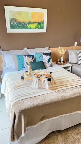 a large bed with a table on top of it at Flat no Aldeia das Águas Park Resort in Barra do Piraí