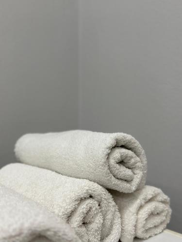 a pile of towels sitting on a table at Tirana Apartment in Kashari