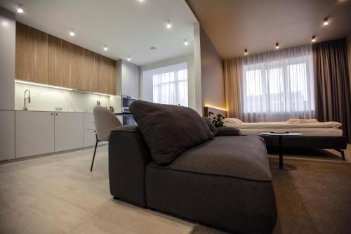 a living room with a couch and a bed at Cactus Apartments 2 in Ivano-Frankivsk