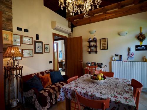 a living room with a table and a couch at Agriturismo Fondo Novelle La Casina in Ferrara