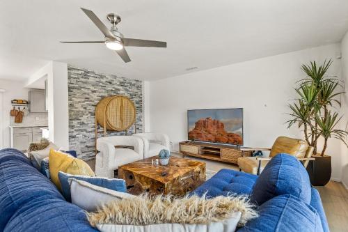 a living room with a blue couch and a table at Trendy 3BR in Sedona: Hot Tub/Fire-pit /Central Location in Sedona
