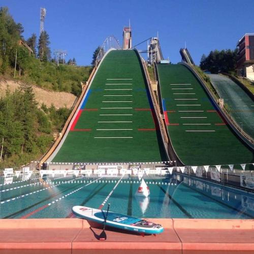 a boat on the water in front of a roller coaster at Mökki in Kalkkinen in Lahti