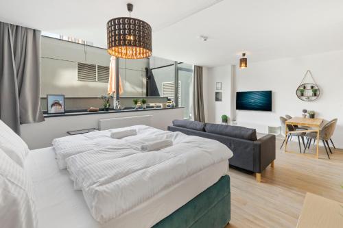 a bedroom with a large bed and a living room at LAM Yacht Club w AC & Terrace in Bratislava