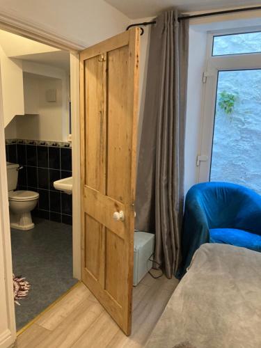 a bathroom with a door open to a bathroom with a toilet at Leigham House in Plymouth