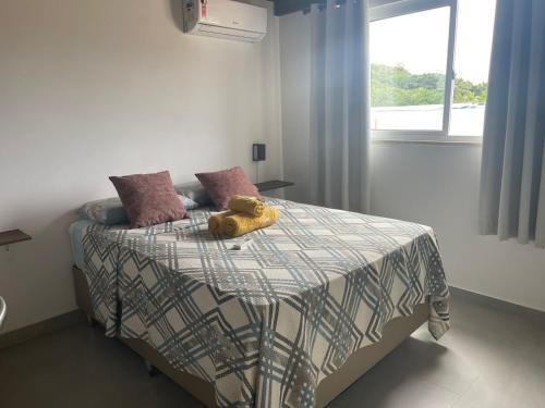 a bedroom with a bed with two teddy bears on it at TRANQUILA FLATS in Morro de São Paulo