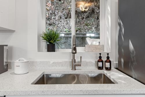 a sink in a kitchen with a window at Private Mountainside Home in Chilliwack