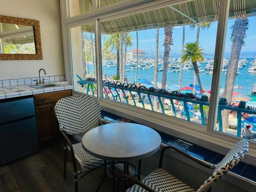 a kitchen with a table and chairs and a view of the water at The Edgewater in Avalon
