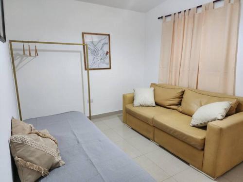 a living room with a couch and a window at Casa en Santiago del Estero Capital in Santiago del Estero
